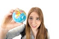 Beautiful student girl holding little world globe in her hand choosing holidays destination in travel tourism concept Royalty Free Stock Photo