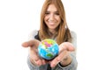 Beautiful student girl holding little world globe in her hand choosing holidays destination in travel tourism concept Royalty Free Stock Photo