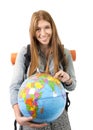 Beautiful student girl holding world globe in her hand choosing holidays destination in travel tourism concept Royalty Free Stock Photo