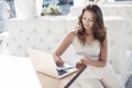 Beautiful student girl preparing for exams sitting at a table outdoors in a summer cafe Royalty Free Stock Photo