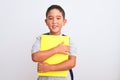 Beautiful student kid boy wearing backpack holding book over isolated white background with a happy face standing and smiling with Royalty Free Stock Photo