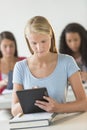 Beautiful Student Using Digital Tablet At Desk Royalty Free Stock Photo