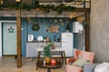 Beautiful Studio apartment in Scandinavian style, decorated for Christmas and New Year, kitchen and table Royalty Free Stock Photo