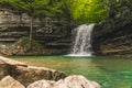 beautiful stunning small and fresh waterfall in the forest in the spring Royalty Free Stock Photo