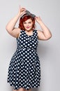 Pin up woman portrait. Beautiful retro female in polka dot dress with red lips and manicure nails and old fshion hairstyle Royalty Free Stock Photo