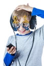 Beautiful stylish blond child wearing big professional headphones and funny glasses Royalty Free Stock Photo