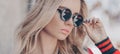Beautiful stylish blonde woman in black sunglasses in outdoor. Banner photo Royalty Free Stock Photo