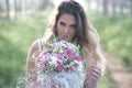 Beautiful stylish bride in a beautiful lush dress in the forest. Royalty Free Stock Photo