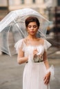 A beautiful stylish bride with an umbrella walks through the old city of Florence.Model with umbrellas in Italy.Tuscany Royalty Free Stock Photo