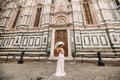 A beautiful stylish bride with an umbrella walks through the old city of Florence.Model with umbrellas in Italy.Tuscany Royalty Free Stock Photo