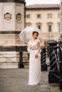 A beautiful stylish bride with an umbrella walks through the old city of Florence.Model with umbrellas in Italy.Tuscany Royalty Free Stock Photo