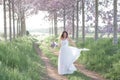 Beautiful stylish bride in a wedding dress dancing in a spring forest . Royalty Free Stock Photo