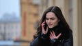 Beautiful stylish brunette girl talking on the phone on the street Royalty Free Stock Photo