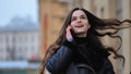 Beautiful stylish brunette girl talking on the phone on the street Royalty Free Stock Photo