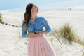 Beautiful and stylish brunette walking on the beach. Portrait in profile Royalty Free Stock Photo