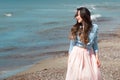 Beautiful and stylish brunette walking on the beach. Portrait in the surf Royalty Free Stock Photo