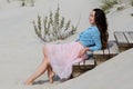 Beautiful and stylish brunette walking on the beach. Sitting on the stairs Royalty Free Stock Photo