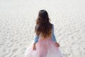 Beautiful and stylish brunette walking on the coast. Back view Royalty Free Stock Photo