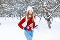 Beautiful stylish girl in a knitted cap, red sweater with a deer Royalty Free Stock Photo