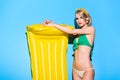 beautiful stylish girl posing in bikini with yellow inflatable mattress Royalty Free Stock Photo