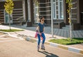 Beautiful stylish girl roller skates around the city. Happy childhood Royalty Free Stock Photo