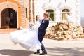 Beautiful stylish groom holding fabulous happy emotional bride and having fun outdoor Royalty Free Stock Photo