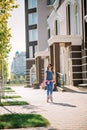 Beautiful stylish little girl roller skates in the sunny city Royalty Free Stock Photo