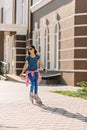 Beautiful stylish little girl roller skates in the sunny city. Healthy lifestyle Royalty Free Stock Photo