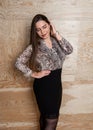 Beautiful stylish plus size girl with long hair posing over wooden background Royalty Free Stock Photo