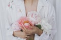 Beautiful stylish woman holding peony bouquet. Sensual young boho female with flowers in hands Royalty Free Stock Photo