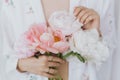 Beautiful stylish woman holding peony bouquet. Sensual young boho female with flowers in hands Royalty Free Stock Photo