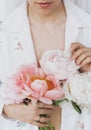 Beautiful stylish woman holding peony bouquet. Sensual young boho female with flowers in hands Royalty Free Stock Photo