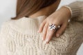 Beautiful stylish woman with modern round ring on hand with white  manicure, close up view Royalty Free Stock Photo