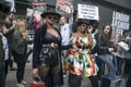 Beautiful and stylish woman posing during the London Fashion Week. Anti fur protest as a background