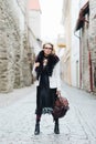 Beautiful, stylish woman posing with a vintage bag Royalty Free Stock Photo