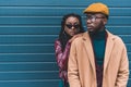 beautiful stylish young african american couple in jacket and overcoat posing together