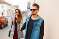 Beautiful stylish young couple with sunglasses in trendy clothes.