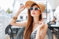 Beautiful stylish young girl in a straw hat and sunglasses Royalty Free Stock Photo