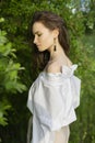 Beautiful stylish young girl wearing a trendy white shirt, beige