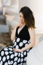 Beautiful stylish young pregnant woman holding her hand on her stomach Royalty Free Stock Photo