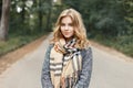 Beautiful stylish young woman in a warm scarf and coat walking Royalty Free Stock Photo