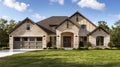 Beautiful suburban home with large front yard, green lawn and garage, front view Royalty Free Stock Photo