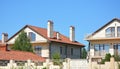 Beautiful suburban luxury modern house with red clay roof, balcony, fence, chimney, garage, patio