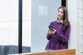 Beautiful successful asian businesswoman holding mobile phone using smartphone in office Royalty Free Stock Photo