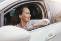 Beautiful successful elegant smiling brunette young woman with red lips driving the passenger car