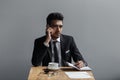 A beautiful successful man talking on phone office in cafe. Royalty Free Stock Photo