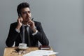 A beautiful successful man talking on phone office in cafe. Royalty Free Stock Photo