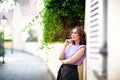 Beautiful successful middle aged woman posing on the street of the old city Royalty Free Stock Photo