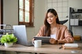 Beautiful Asian businesswoman using digital tablet touchpad at her office desk Royalty Free Stock Photo