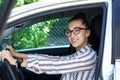 Beautiful successful smiling rich business woman in white suit sitting in gray car salon , wearing glasses talking on phone on a Royalty Free Stock Photo